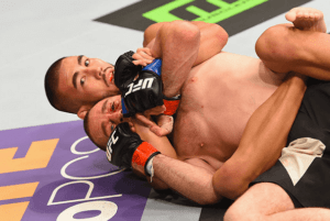 MMA Fighter Hawaiian Lewis Smolka applying a rear naked choke against irishman neil seery